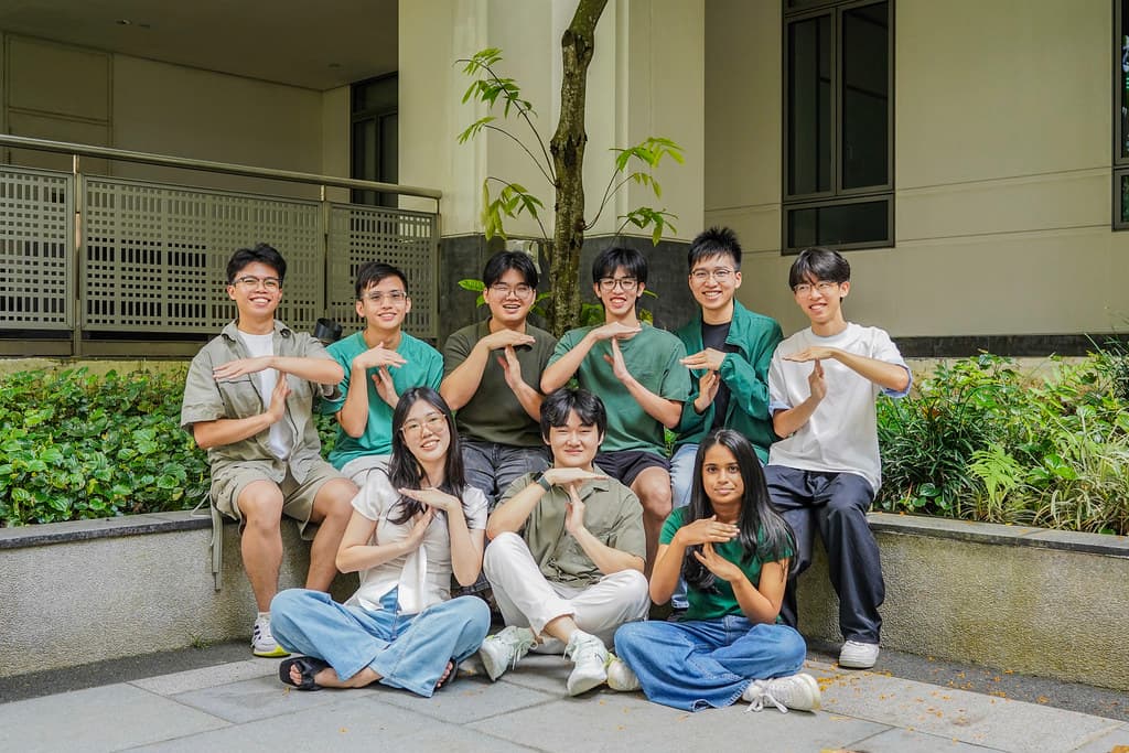 Members of the NUSC Tech Directorate making a T with their hands